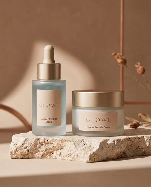GLOWE Copper Peptide Serum and Cream on a travertine plinth